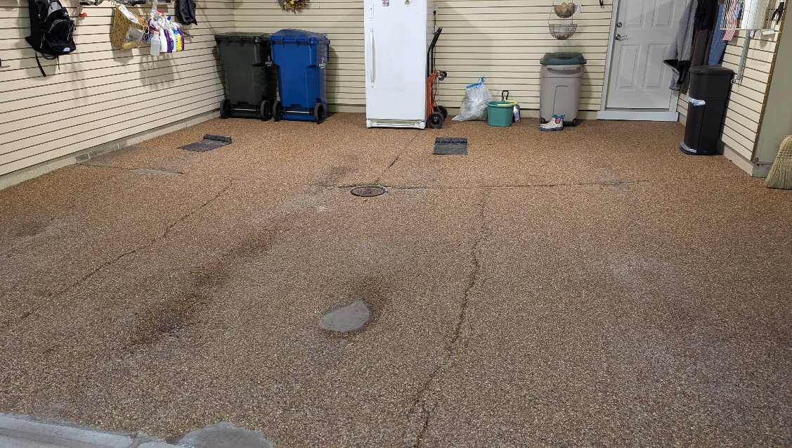 Before: worn, cracked and discolored NatureStone aggregate floor in a Strongsville garage